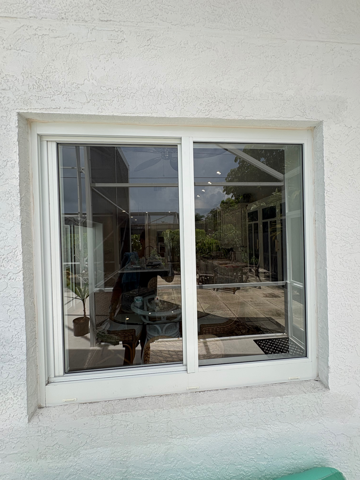 Clean residential sliding window reflecting a bright Port St. Lucie patio